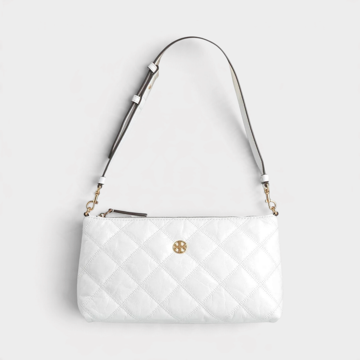 Supplied Fashion Willa white glazed leather shoulder bag with quilted texture, gold hardware, and zip closure.